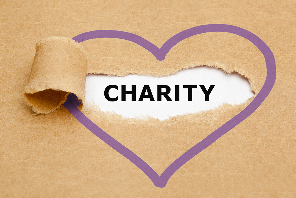 cardboard texture with the word "Charity" in the outline of a purple heart