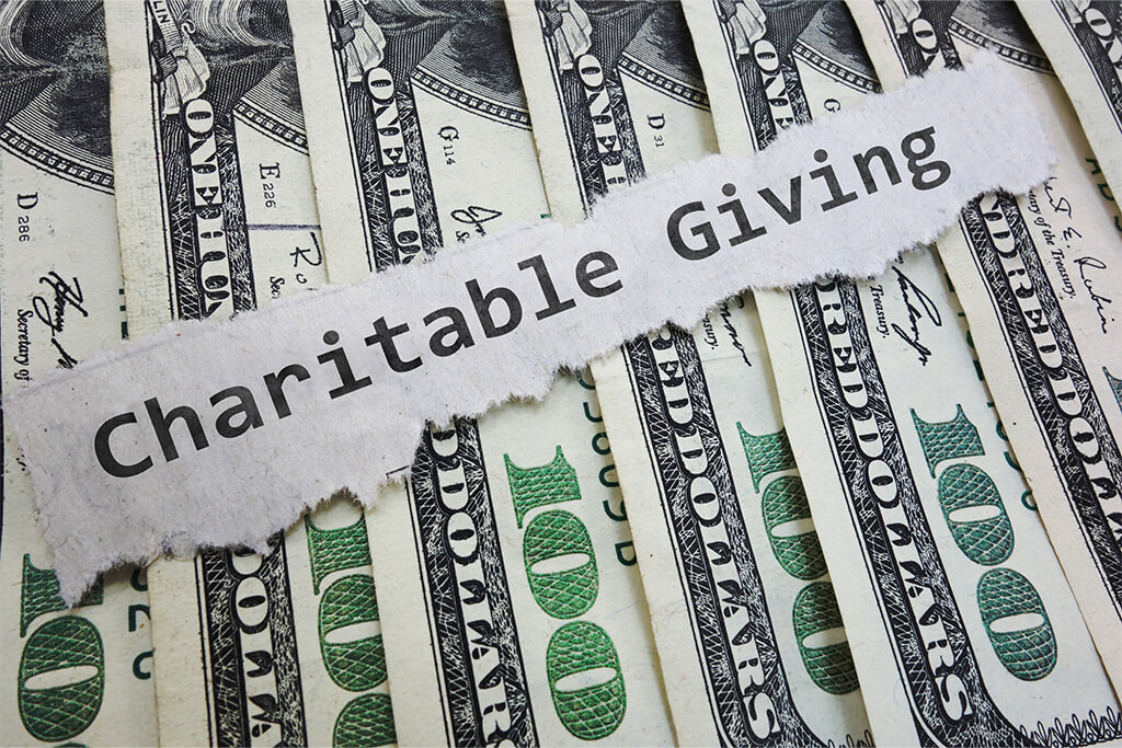 the words "Charitable Giving" over money