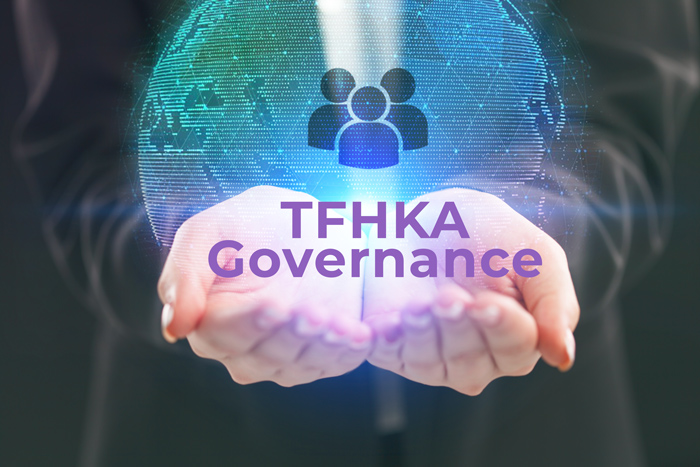 person holding holographic globe with the words, "TFHKA Governance"